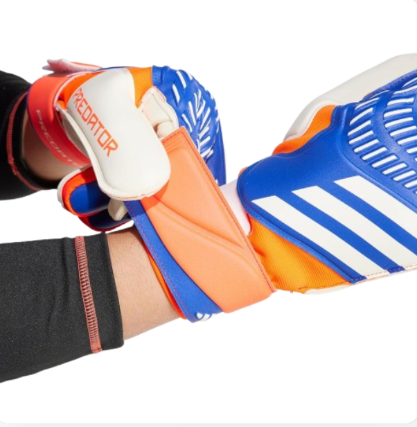 Close-up of a person wearing orange and blue sports shoes with visible branding on a white background.